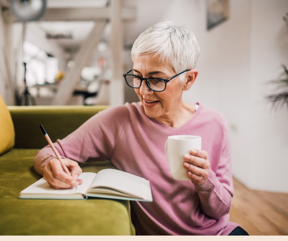 photo of a white haired woman writing in a notebook