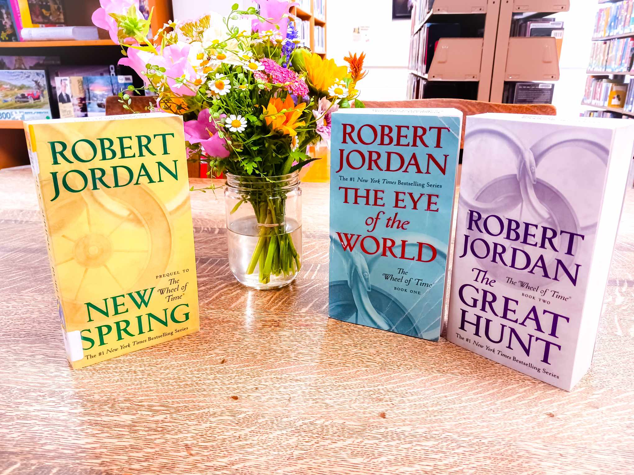 photograph of books - Wheel of Time series: "New Spring," "The Eye of the World," and "The Great Hunt"