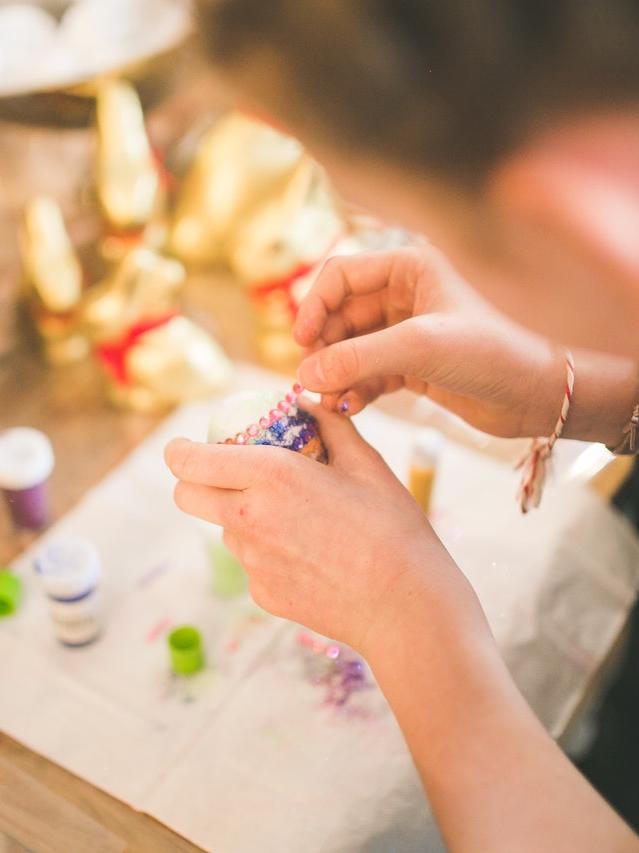 image of a person's hands making something with craft materials