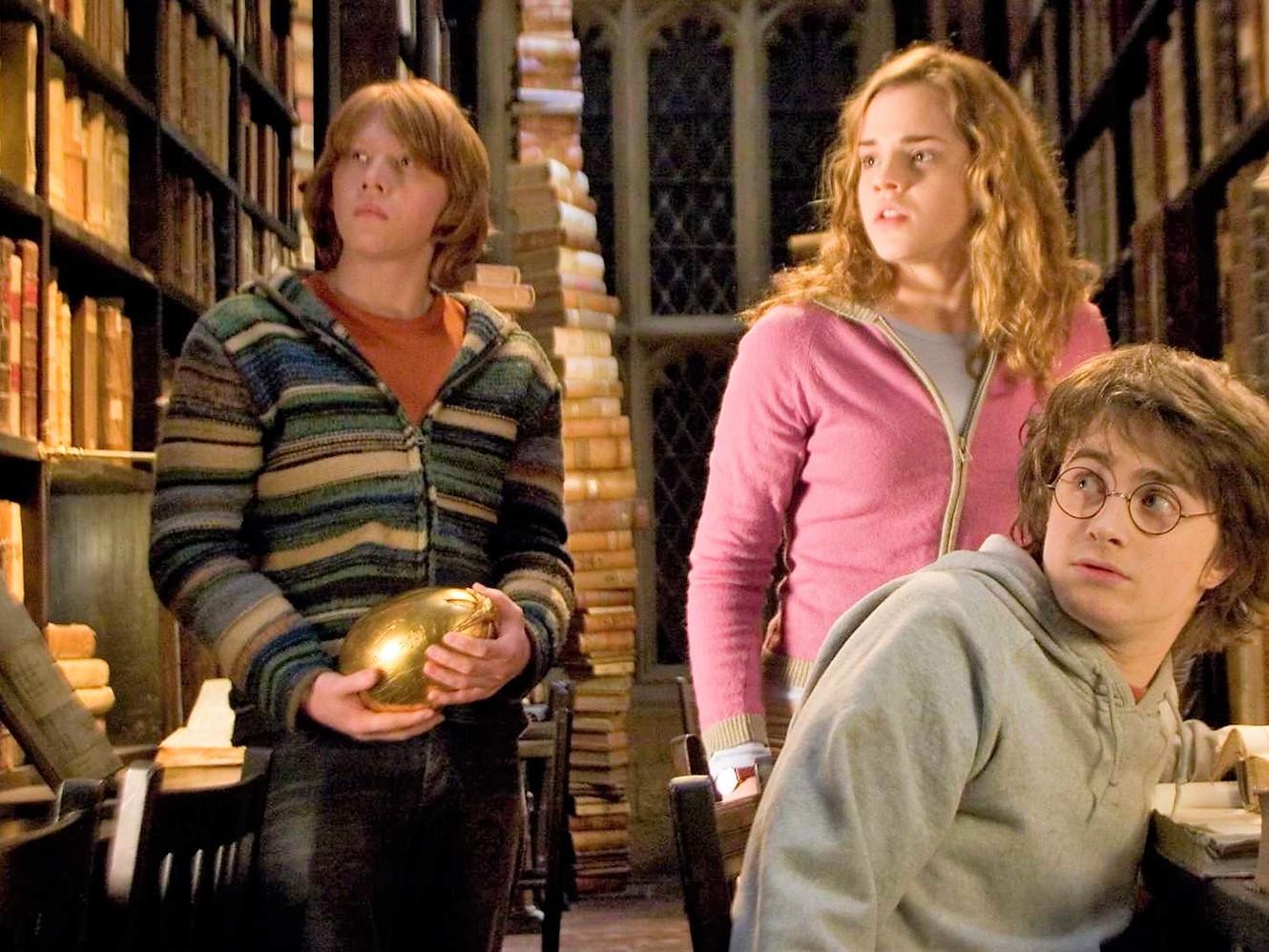 Harry Potter and friends at their school library at Hogwarts.